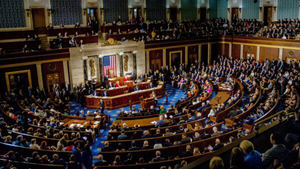 A sitting of the U.S. Congress. Members of the 115th congress and their familes mingle on the house floor while attending the joint session on the opening day of the current session.